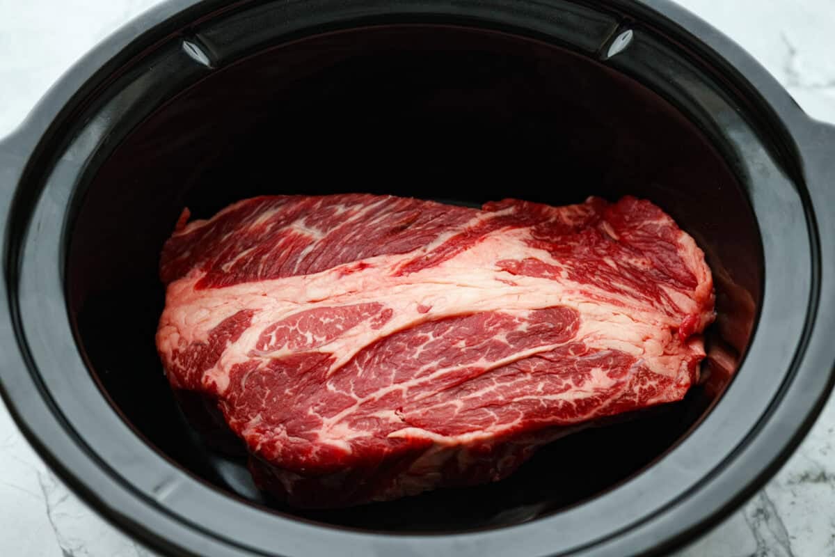 This 4 Ingredient Mushroom Beef is just like how my grandma used to make her Sunday roast, simple and cozy. You toss it all in the crockpot, and it comes out melt in your mouth tender with a rich gravy thatโs perfect over everything. Chuck roast in the bottom of a crockpot.