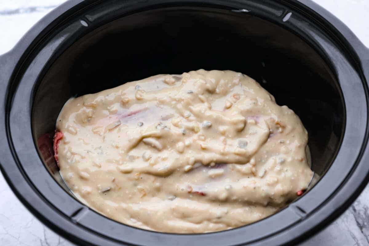 This 4 Ingredient Mushroom Beef is just like how my grandma used to make her Sunday roast, simple and cozy. You toss it all in the crockpot, and it comes out melt in your mouth tender with a rich gravy thatโs perfect over everything. Gravy add to the top of the chuck roast in the crockpot, ready to cook.