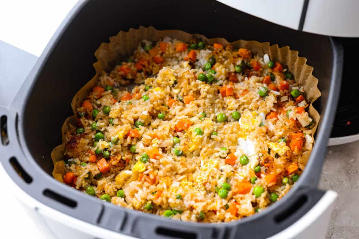 Did you know you can make fried rice in the air fryer? My Air Fryer Fried Rice recipe takes something already simple and makes it even easier. You get golden, slightly crispy rice, tender veggies, and the best flavor with hardly any effort. Cooked eggs stirred into the rice mixture in the air fryer basket.