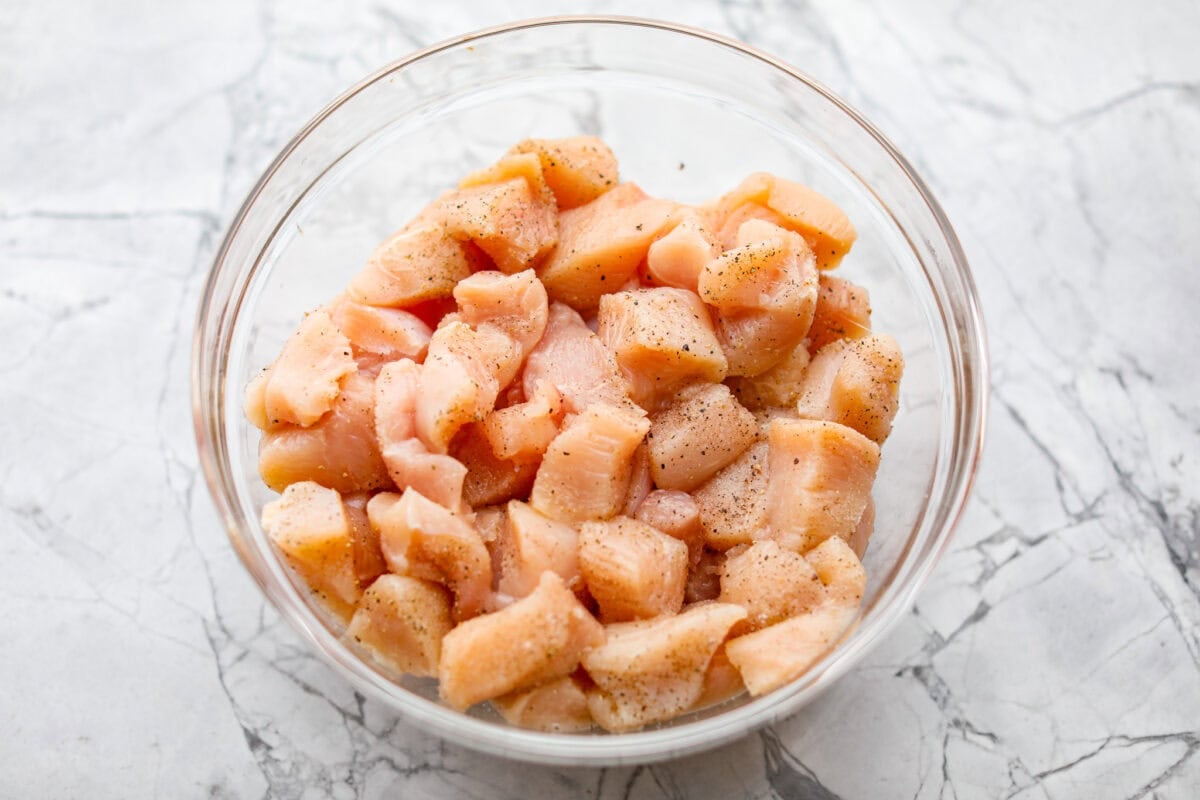 I'm updating my "Tuesday night dinner that feels like we're in Hawaii" with double the sauce! You guys asked, so I added more of that sweet, tangy, deliciousness to this Baked Sweet Hawaiian chicken! It's easy, even after a busy day! Diced chicken seasoned with salt and pepper.