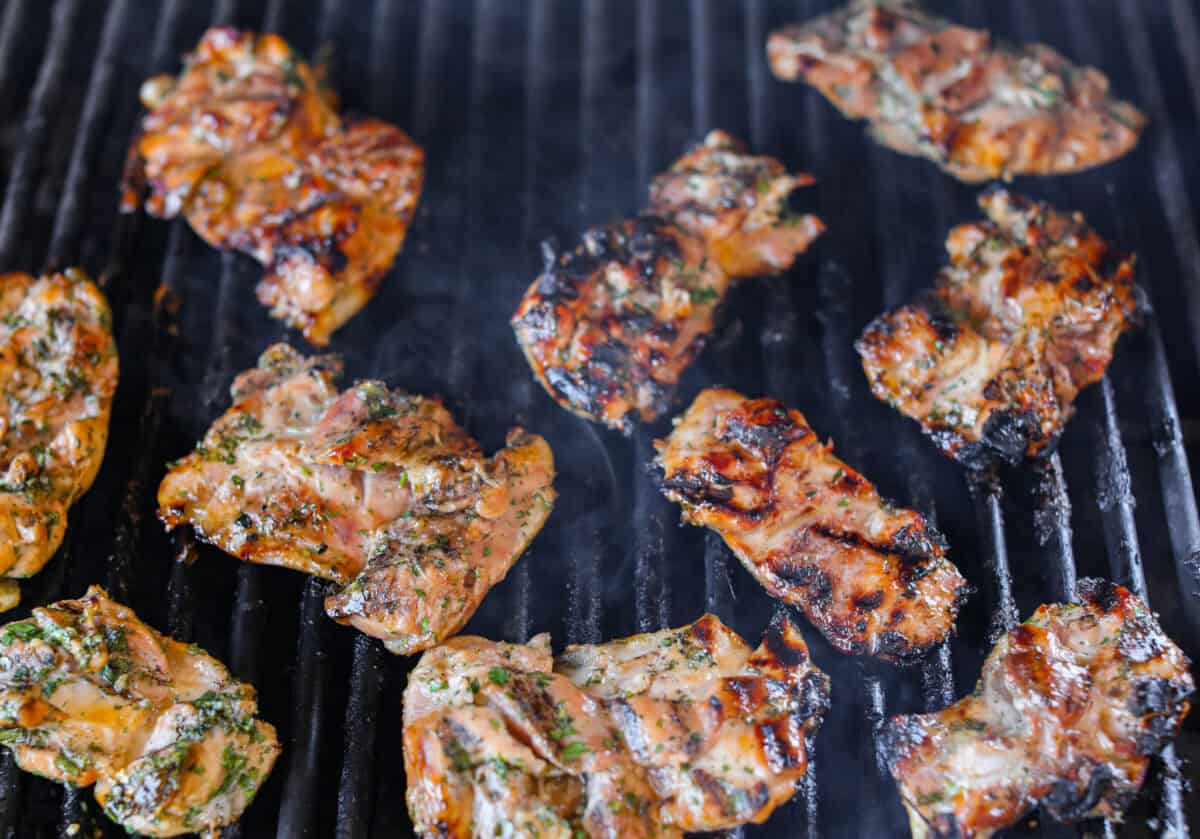 This grilled honey lime cilantro chicken is made for summer nights. It’s fresh, a little sweet, a little tangy, and packed with flavor. I make this on repeat when I need something easy that still feels like a real dinner. Marinated chicken being cooked on a grill.