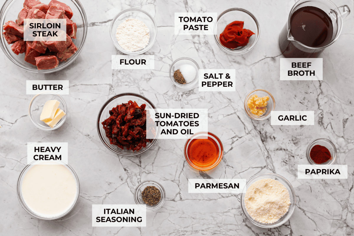 These marry me steak bites bring the flavor! Juicy, seared steak is tossed in a rich, creamy sauce with sun-dried tomatoes and bold, layered flavor. They're quick to make and perfect for spooning over potatoes or soaking up with veggies. Overhead shot of labeled ingredients.