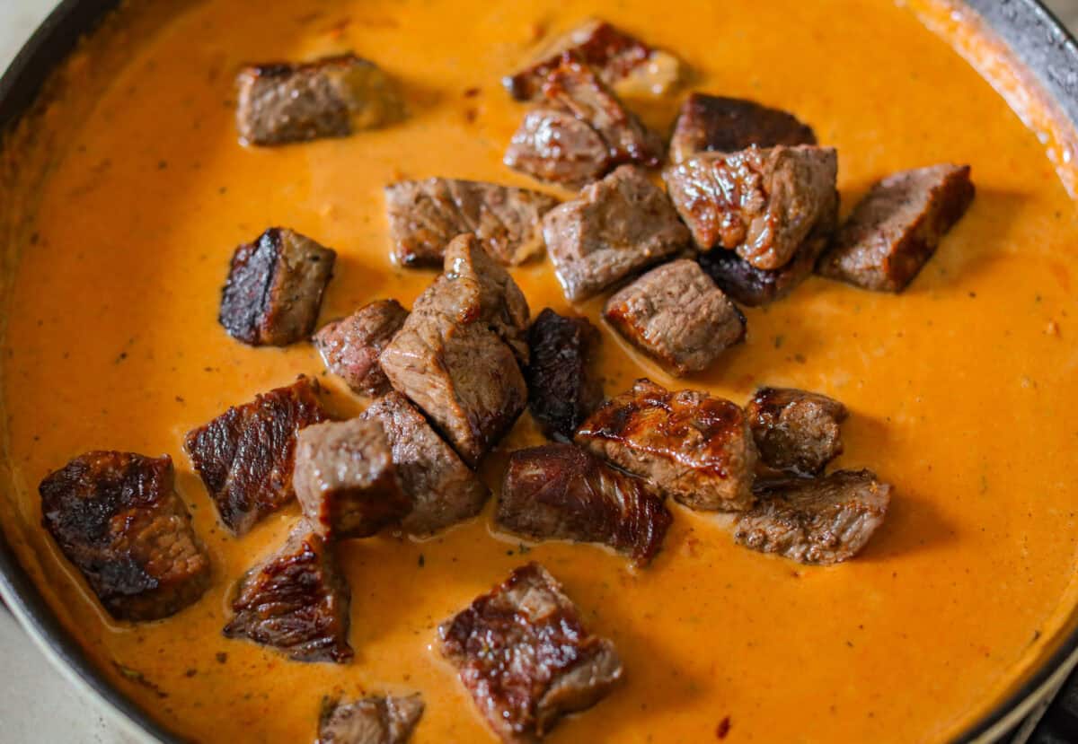 These marry me steak bites bring the flavor! Juicy, seared steak is tossed in a rich, creamy sauce with sun-dried tomatoes and bold, layered flavor. They're quick to make and perfect for spooning over potatoes or soaking up with veggies. Marry me steak bites added to the sauce.