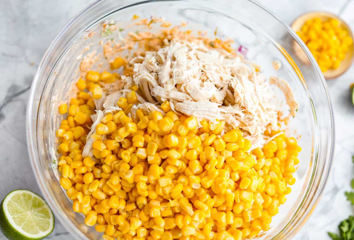 This Mexican Street Corn Chicken Casserole takes everything you love about elote, tangy lime, smoky Tajin, and creamy cotija, and turns it into one bubbly, cheesy weeknight dinner the whole family will devour! Corn and chicken added to the mixed up sauce ingredients.