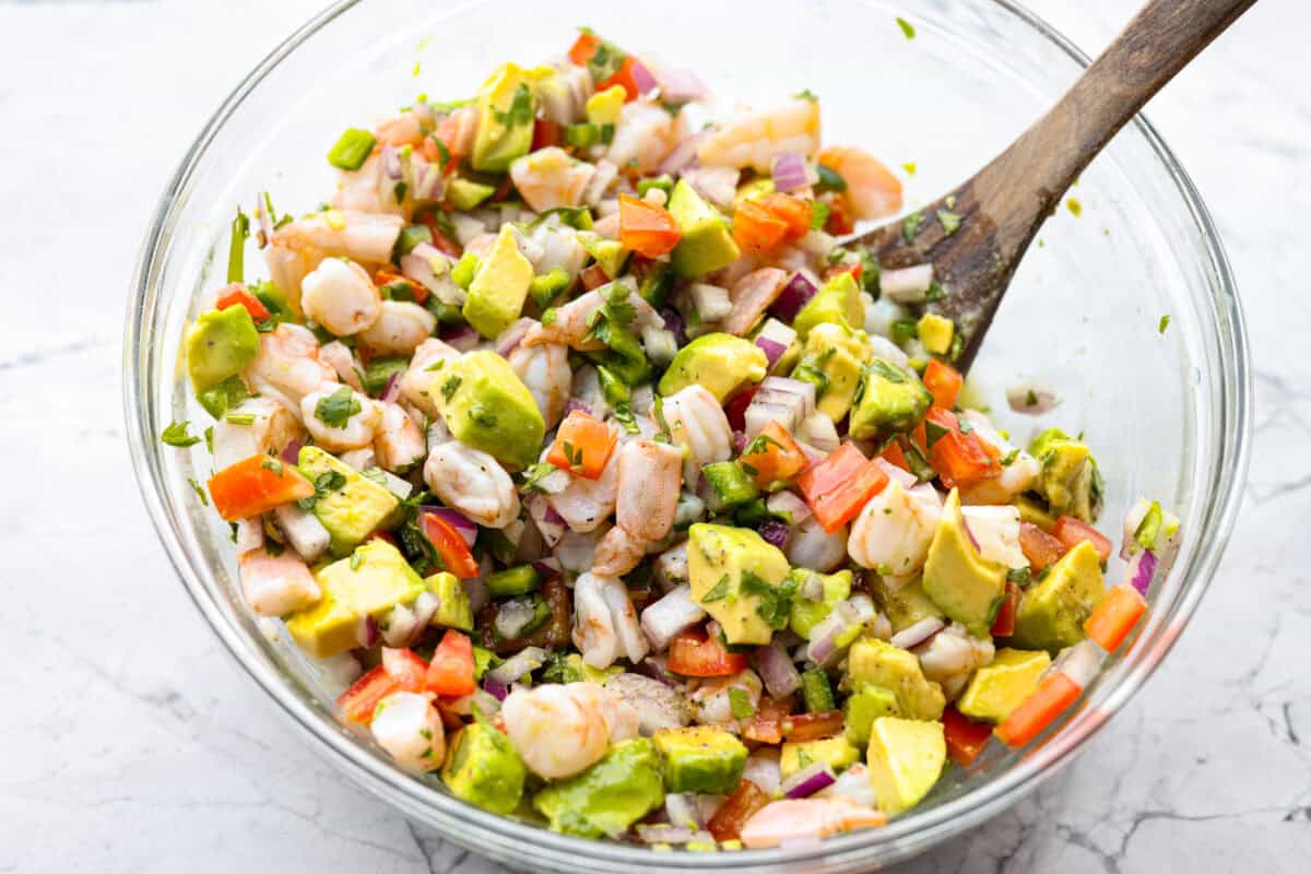 If you're anything like me, you LOVE shrimp ceviche! My version has avocado and is fresh, bright, and has the most incredible flavor. It's the perfect no-cook dish for warm weather. Make it, trust me, you will thank me later! All of the ingredients mixed together in a bowl.