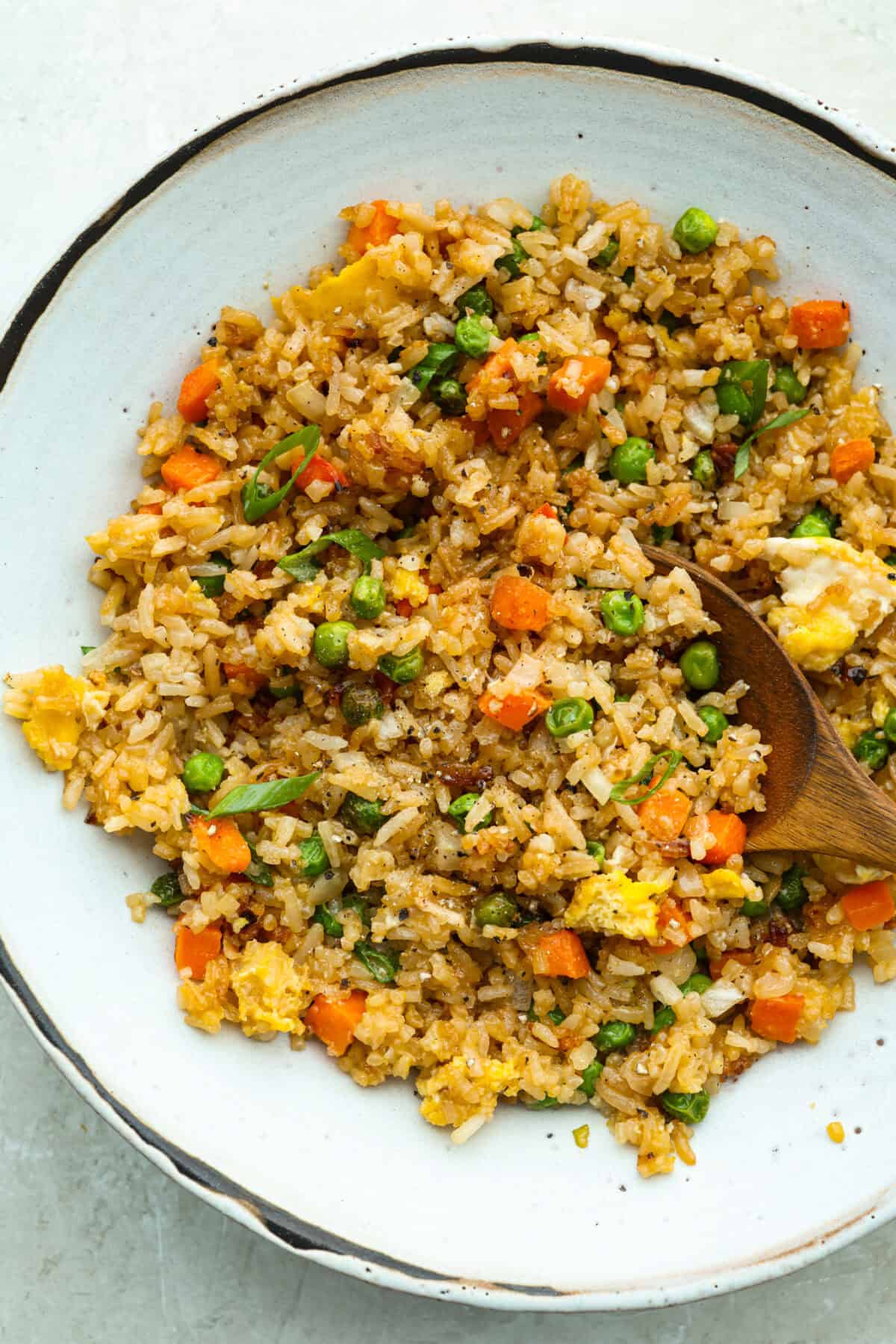 Did you know you can make fried rice in the air fryer? My Air Fryer Fried Rice recipe takes something already simple and makes it even easier. You get golden, slightly crispy rice, tender veggies, and the best flavor with hardly any effort. Bowl of air fryer fried rice.