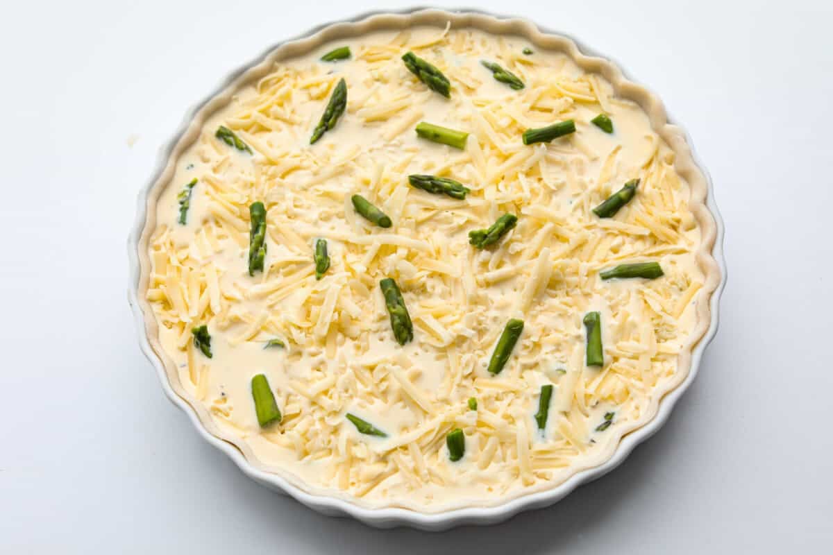 My asparagus quiche is one of those recipes I wait all year to make. Itโs creamy, cheesy, and those bright green asparagus pieces make every slice feel fresh and so good. Itโs simple, itโs pretty, and I love making it for a spring brunch! Asparagus quiche all ready to go in the oven.
