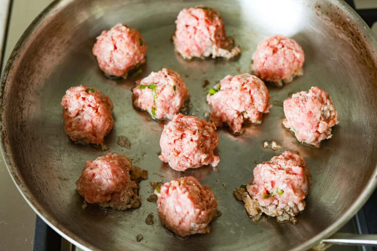 Blanket dumplings are a viral dumpling hack where you cook the filling and press the wrappers right on top. They are the ultimate shortcut to homemade dumplings, ready in just 30 minutes! Trust me, you will want to make these! Meat balls in a hot skillet.