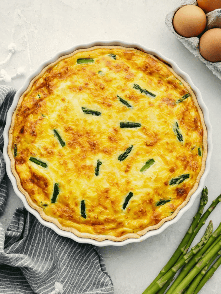 My asparagus quiche is one of those recipes I wait all year to make. Itโs creamy, cheesy, and those bright green asparagus pieces make every slice feel fresh and so good. Itโs simple, itโs pretty, and I love making it for a spring brunch! Fully baked asparagus quiche.