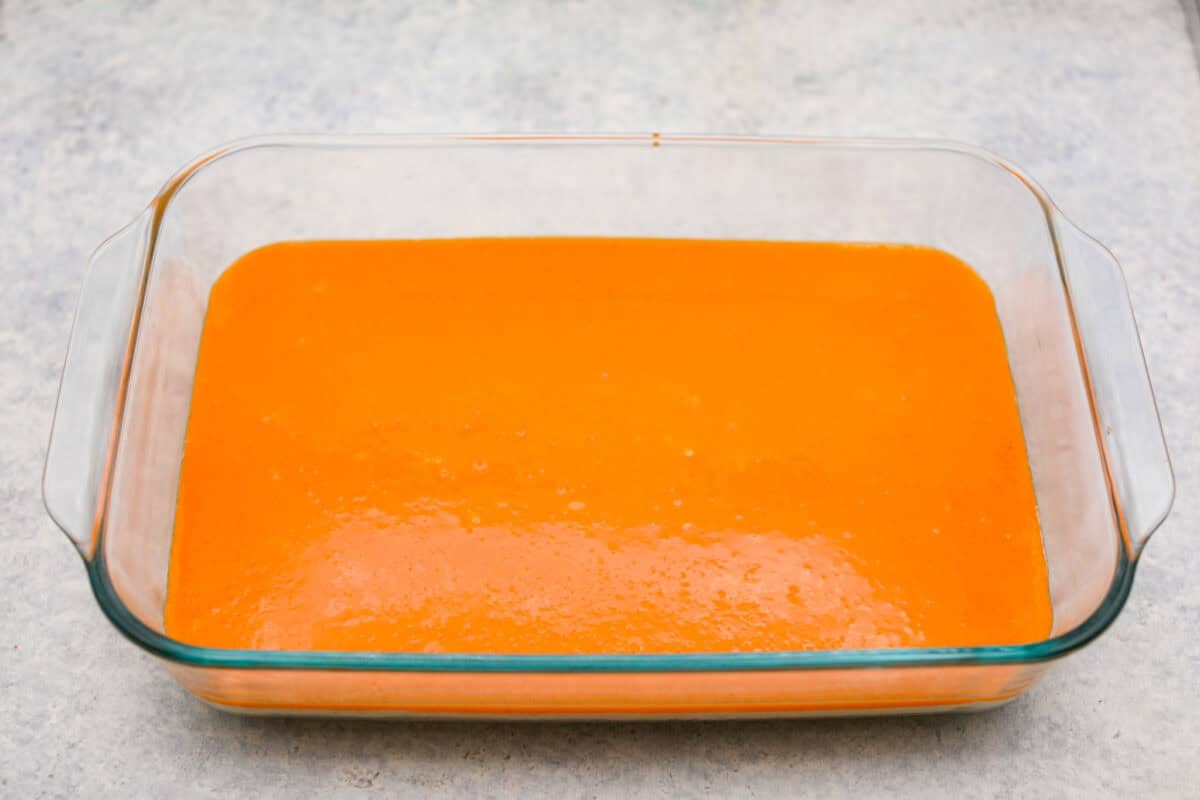 Orange creamsicle lush is sunshine in dessert form! With creamy orange layers, a buttery golden Oreo crust, and bright fresh citrus flavor, this easy no-bake dessert is a fun twist on my popular Lemon Lush thatโs perfect for summer. Orange creamsicle lush mixture on top of the cream cheese layer.