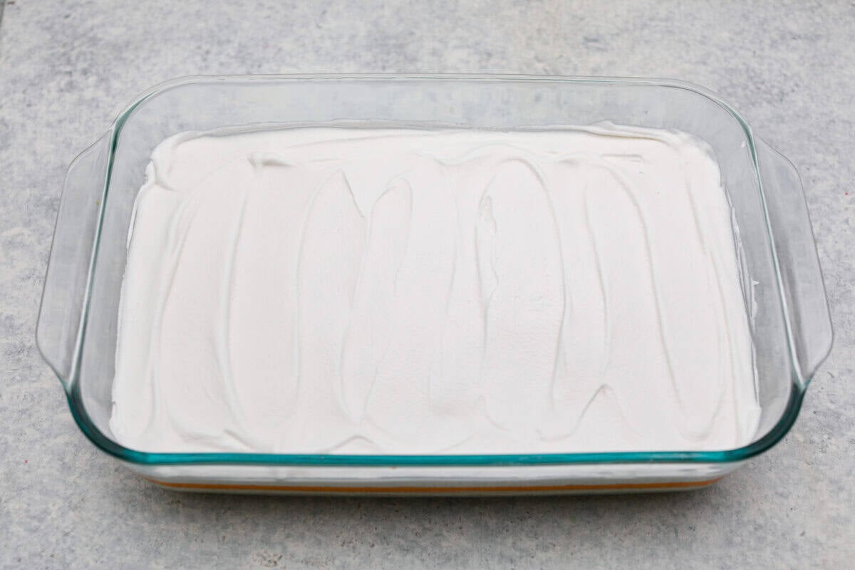 Orange creamsicle lush is sunshine in dessert form! With creamy orange layers, a buttery golden Oreo crust, and bright fresh citrus flavor, this easy no-bake dessert is a fun twist on my popular Lemon Lush thatโs perfect for summer. Whipped topping layer on top of the orange layers.