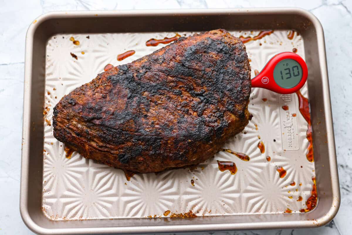 Santa Maria grilled tri-tip is juicy, smoky, and loaded with bold flavor from a delicious spice rub. Grilled until perfectly tender with a gorgeous crust, itโs an easy recipe thatโs always a hit at cookouts and summer dinners. Instant read thermometer checking the temperature of the cooked meat.