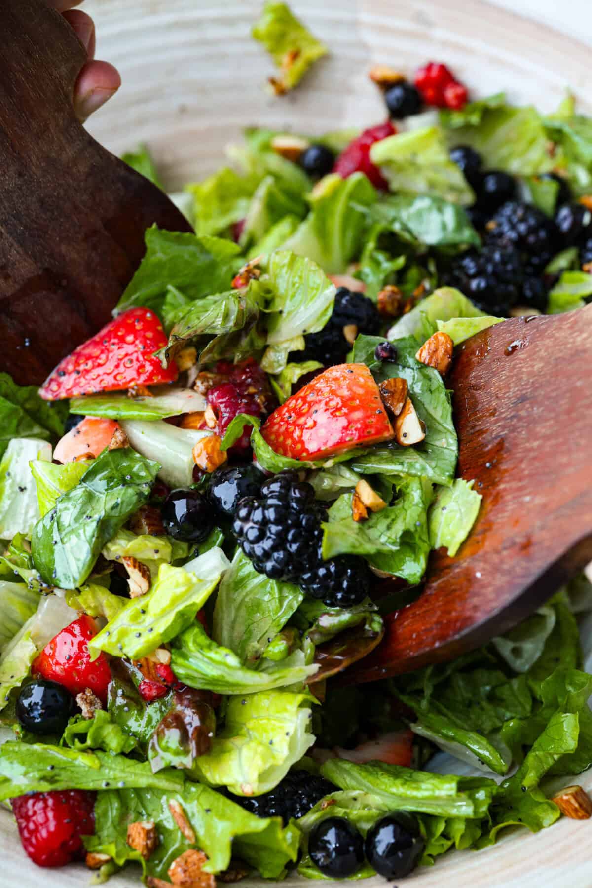 This copycat Zupa’s Nuts About Berries Salad is fresh, bright, and full of texture in every bite. Loaded with sweet berries, crunchy cinnamon almonds, crisp greens, and creamy poppyseed dressing, it tastes just like the restaurant favorite right at home! Close up shot of the nuts about berries salad.