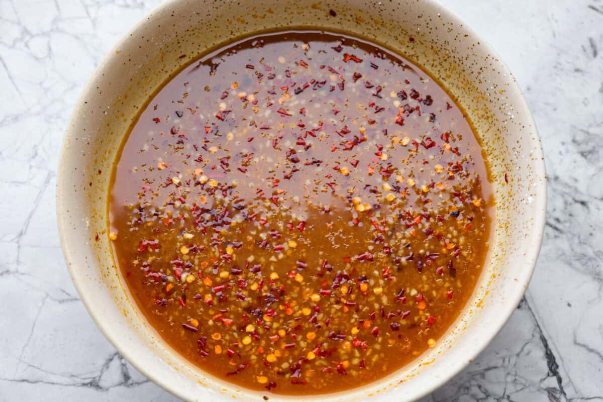 Skip the drive-thru and make this copycat Panda Express orange chicken at home! Crispy chicken coated in a sweet, sticky orange sauce with a secret ingredient that makes it taste just like the real thing. Perfect for an easy takeout-style dinner the whole family will love. All of the sauce ingredients whisked together in a bowl.