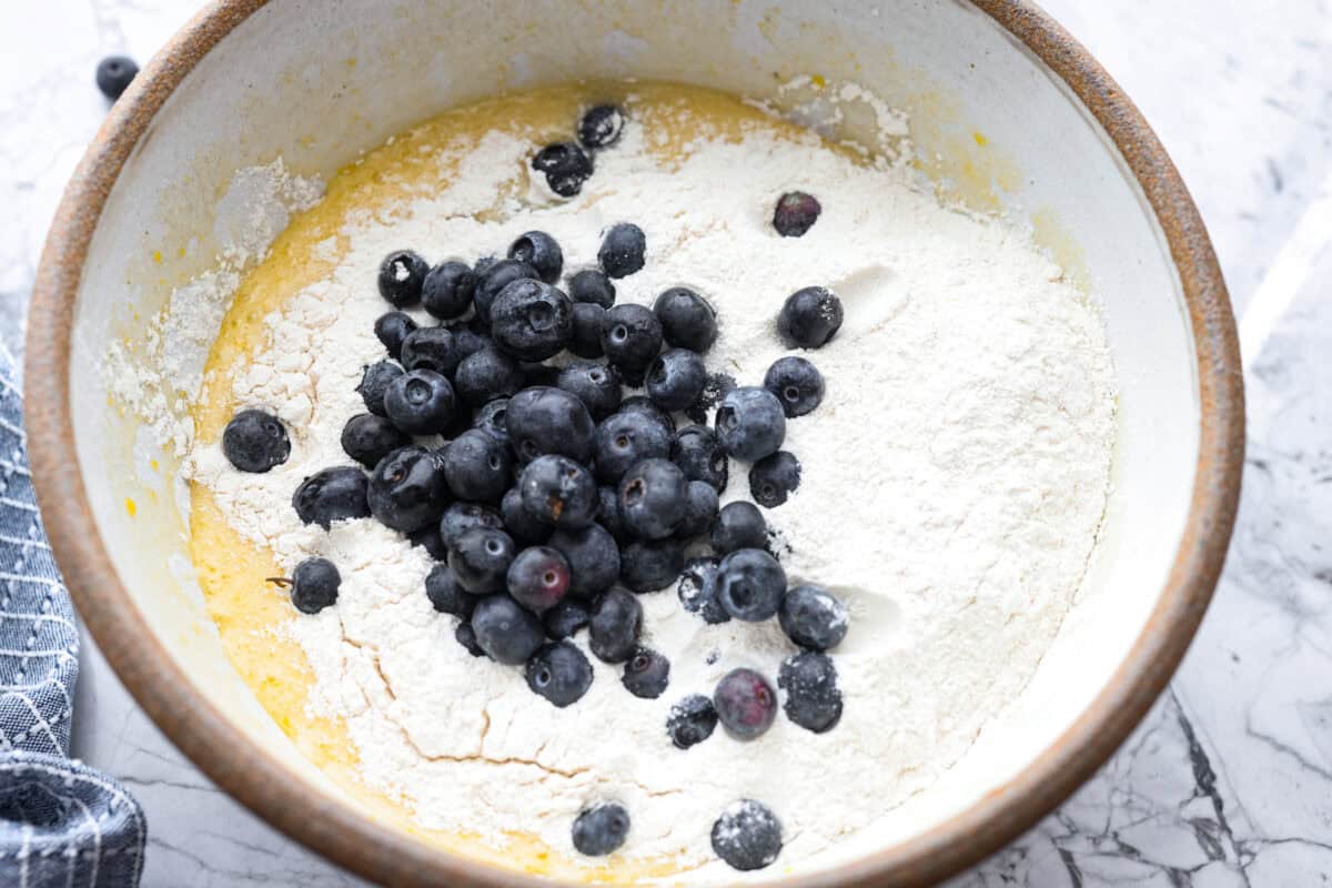 This 5 Ingredient Blueberry Bread is the little shortcut loaf youโll make once and then suddenly need every weekend. Itโs soft, sweet, full of juicy blueberries, and comes together with only five simple ingredients. Butter mixture with flour and blueberries on top.