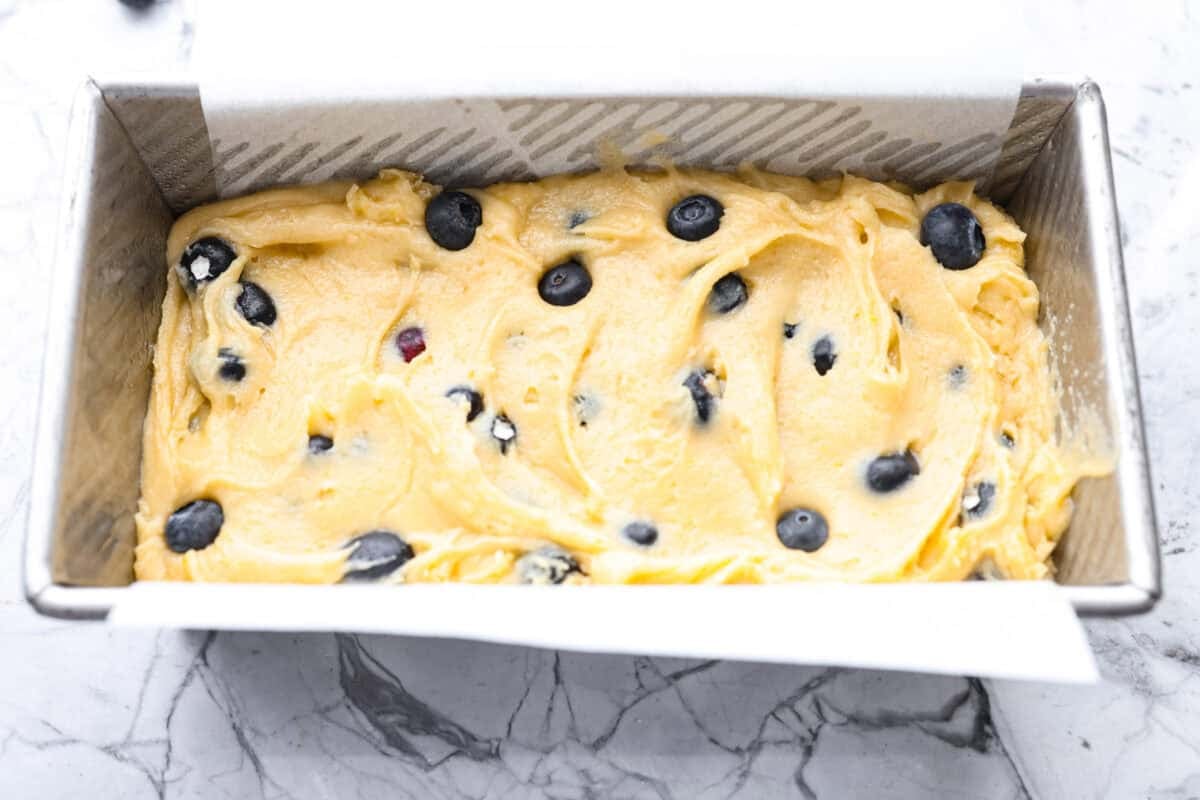 This 5 Ingredient Blueberry Bread is the little shortcut loaf youโll make once and then suddenly need every weekend. Itโs soft, sweet, full of juicy blueberries, and comes together with only five simple ingredients. 5 ingredient blueberry bread batter added to a loaf pan.