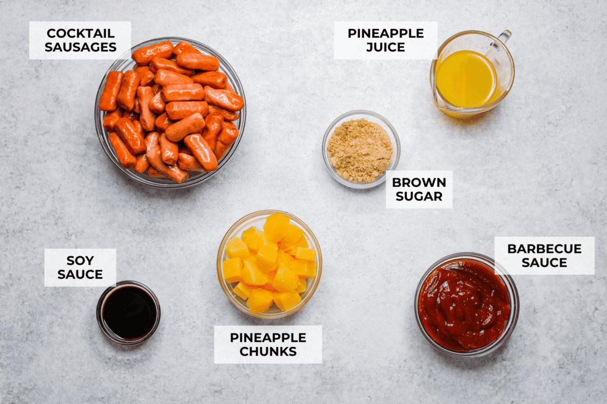 Don't be surprised if these Hawaiian Lil' Smokies steal the show! Slow cooked in a sweet and tangy pineapple BBQ sauce, they're bite-sized, irresistible, and dangerously easy to snack on. Overhead shot of labeled Hawaiian lil' smokies ingredients.