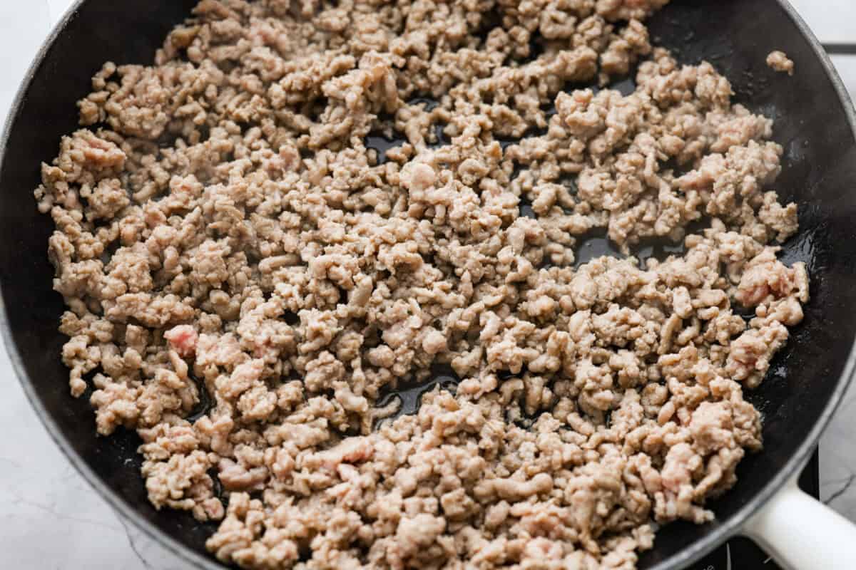 These dragon noodles are the ultimate weeknight dinner when youโre craving big flavor fast. Tender noodles, spicy-sweet sauce, and savory pork come together for a dish thatโs fast, fiery, and seriously addictive. Ground pork cooking in a skillet.