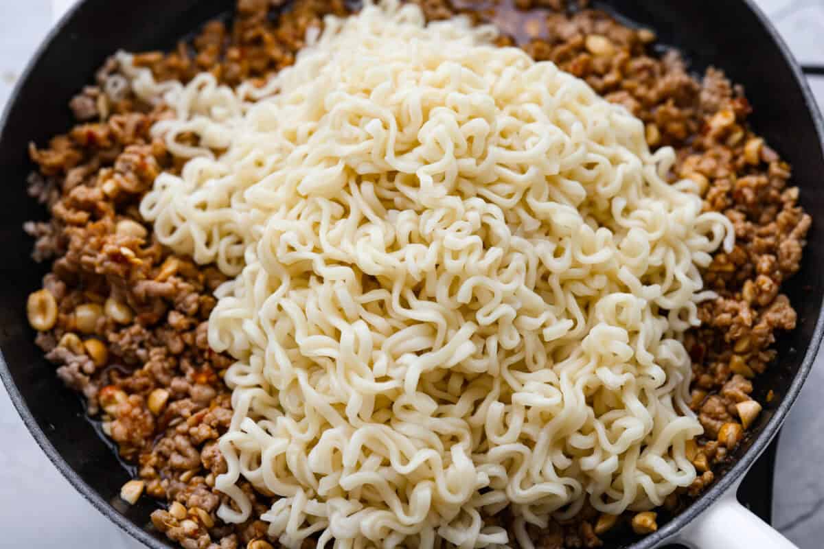 These dragon noodles are the ultimate weeknight dinner when youโre craving big flavor fast. Tender noodles, spicy-sweet sauce, and savory pork come together for a dish thatโs fast, fiery, and seriously addictive. Noodles added to the meat and sauce mixture.