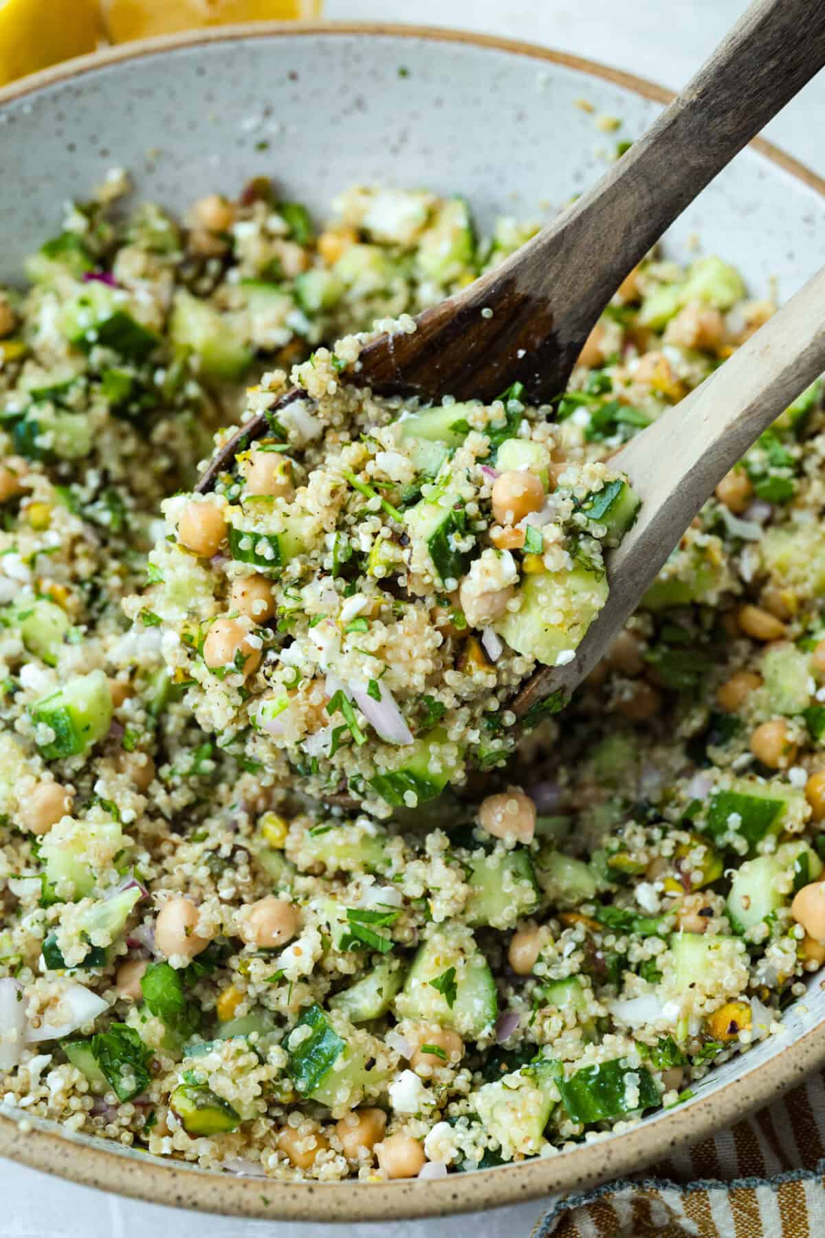 This Jennifer Aniston Salad is light, fresh, and perfect for summer lunches. Itโs packed with veggies, chickpeas, herbs, pistachios, and feta, then tossed in a simple lemon dressing that makes everything taste bright and delicious. Close up shot of a scoop of Jennifer Aniston salad.