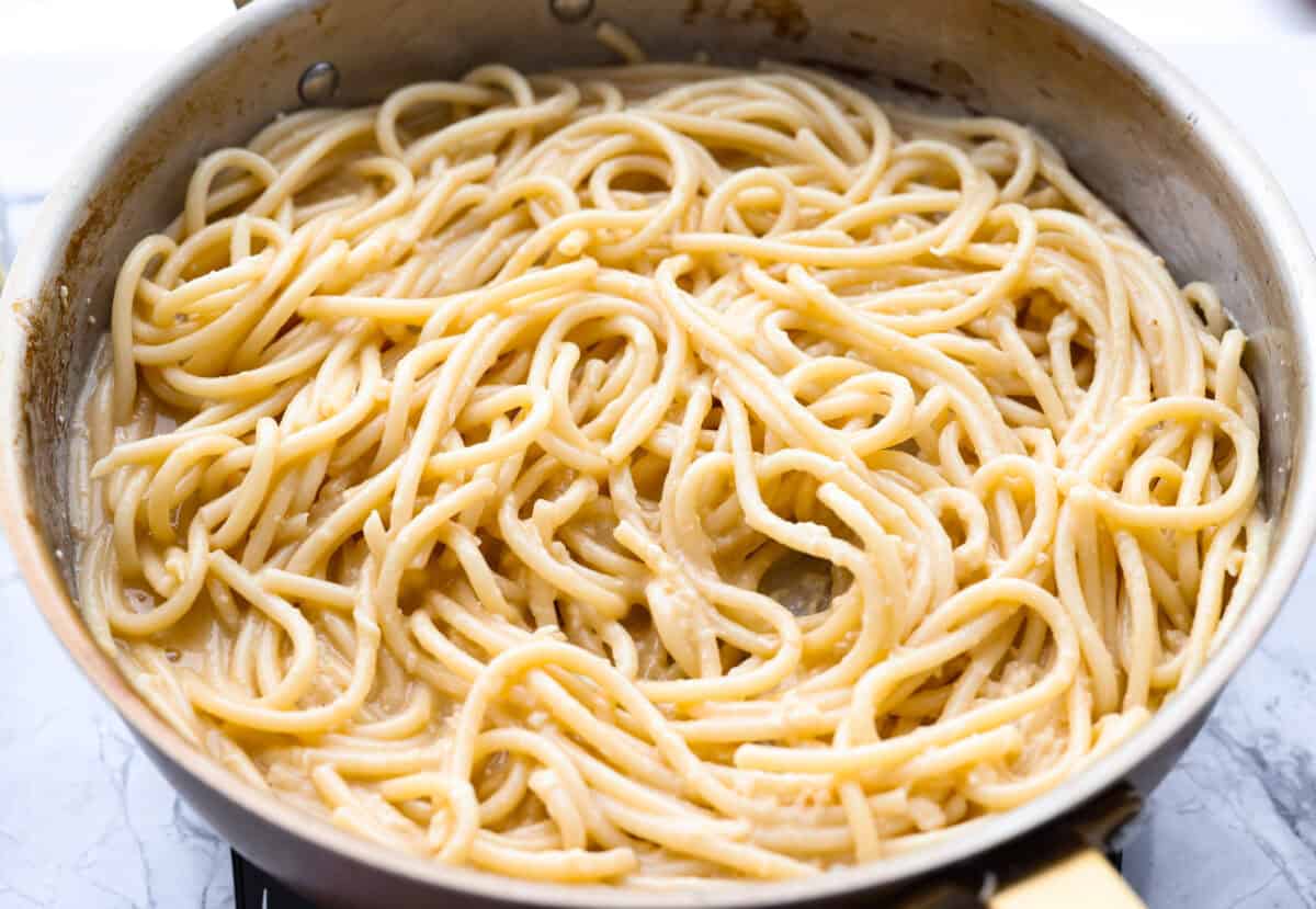 My 5-ingredient miso pasta turns pantry staples into something you'd swear came from a restaurant kitchen. Butter, garlic, and miso melt together into a rich, savory sauce that clings to every strand of bucatini. Cooked noodles added to the skillet.