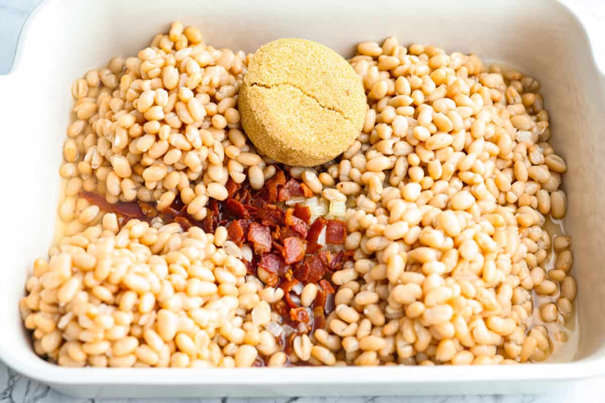 You're going to want this Copycat Grandma Brown’s Famous Baked Beans recipe in your life! It’s sweet, smoky, simple, and the perfect side dish for BBQs, summer cookouts, and every family get together. Beans, bacon, onions and sugar added to the baking dish.