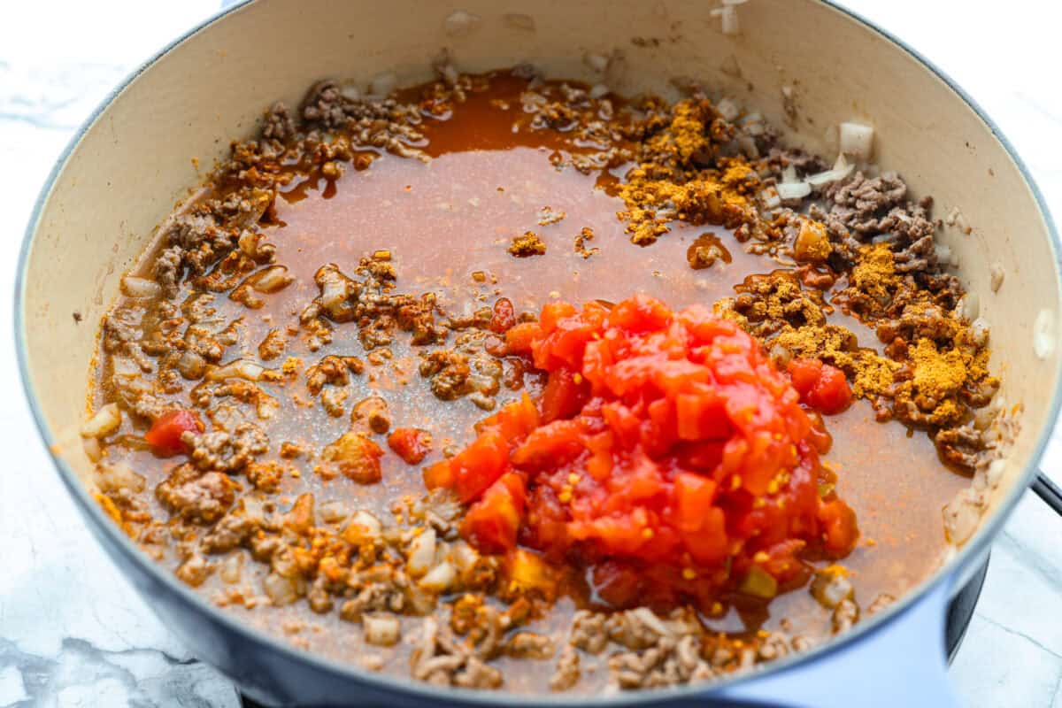 If your family loves tacos and mac and cheese, this one pan taco mac is about to become a weeknight favorite! It's cheesy, hearty, packed with Tex-Mex flavor, and comes together in one skillet in just 30 minutes. Taco mac ingrediets added to the skillet with the brown beef.