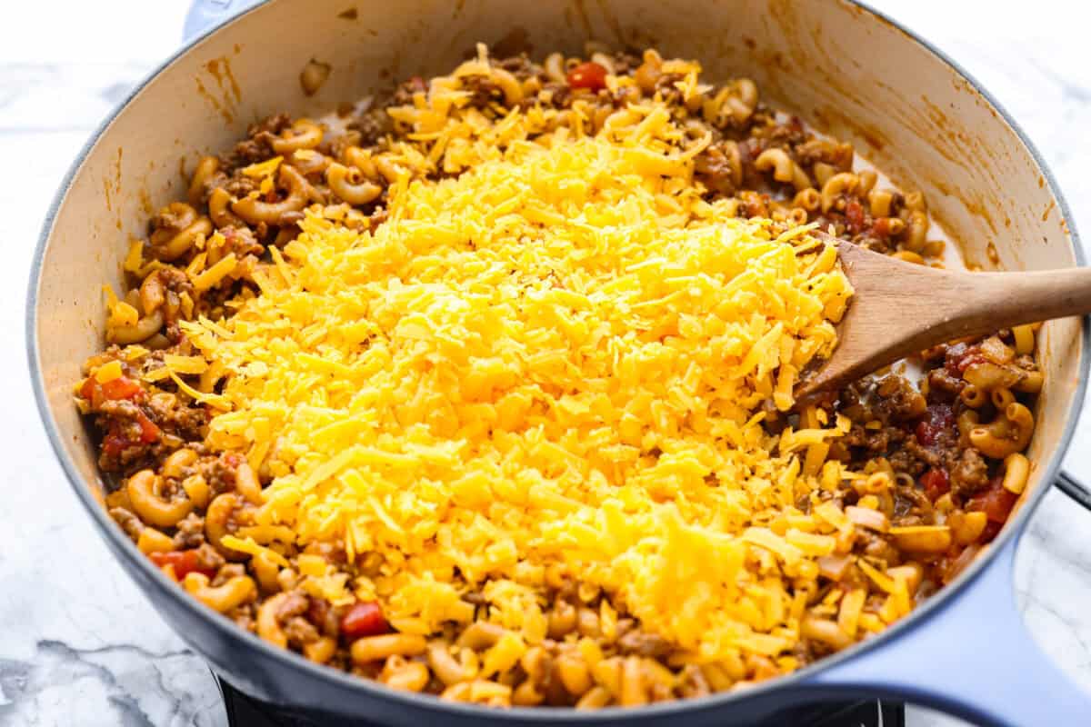 If your family loves tacos and mac and cheese, this one pan taco mac is about to become a weeknight favorite! It's cheesy, hearty, packed with Tex-Mex flavor, and comes together in one skillet in just 30 minutes. Cheese added to the cooked down beef and noodle mixture.