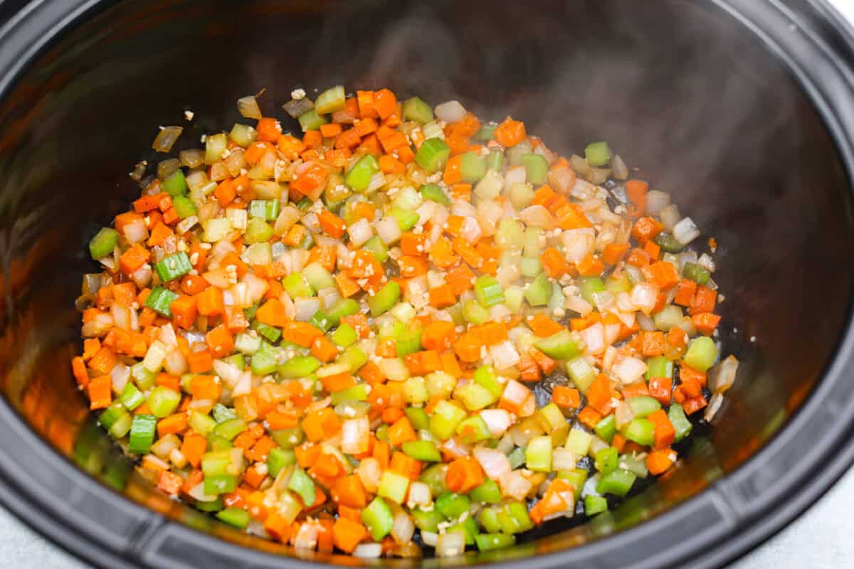 Veggies in the bottom of a slow cooker. 