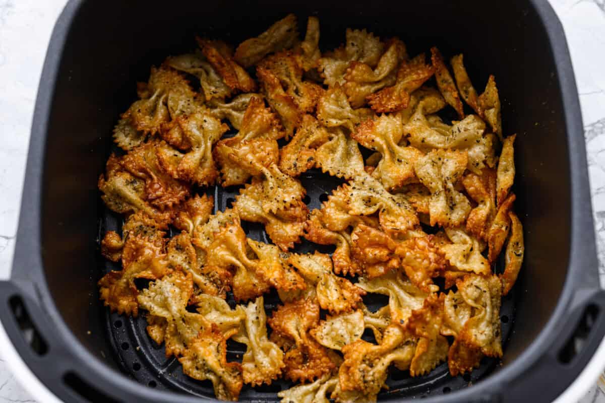 Cooked pasta cooked in the air fryer basket. 