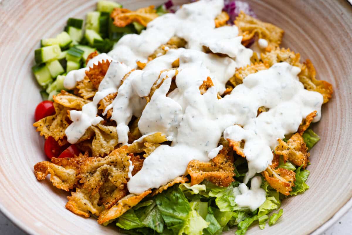 Dressing poured over the top of the salad ingredients. 