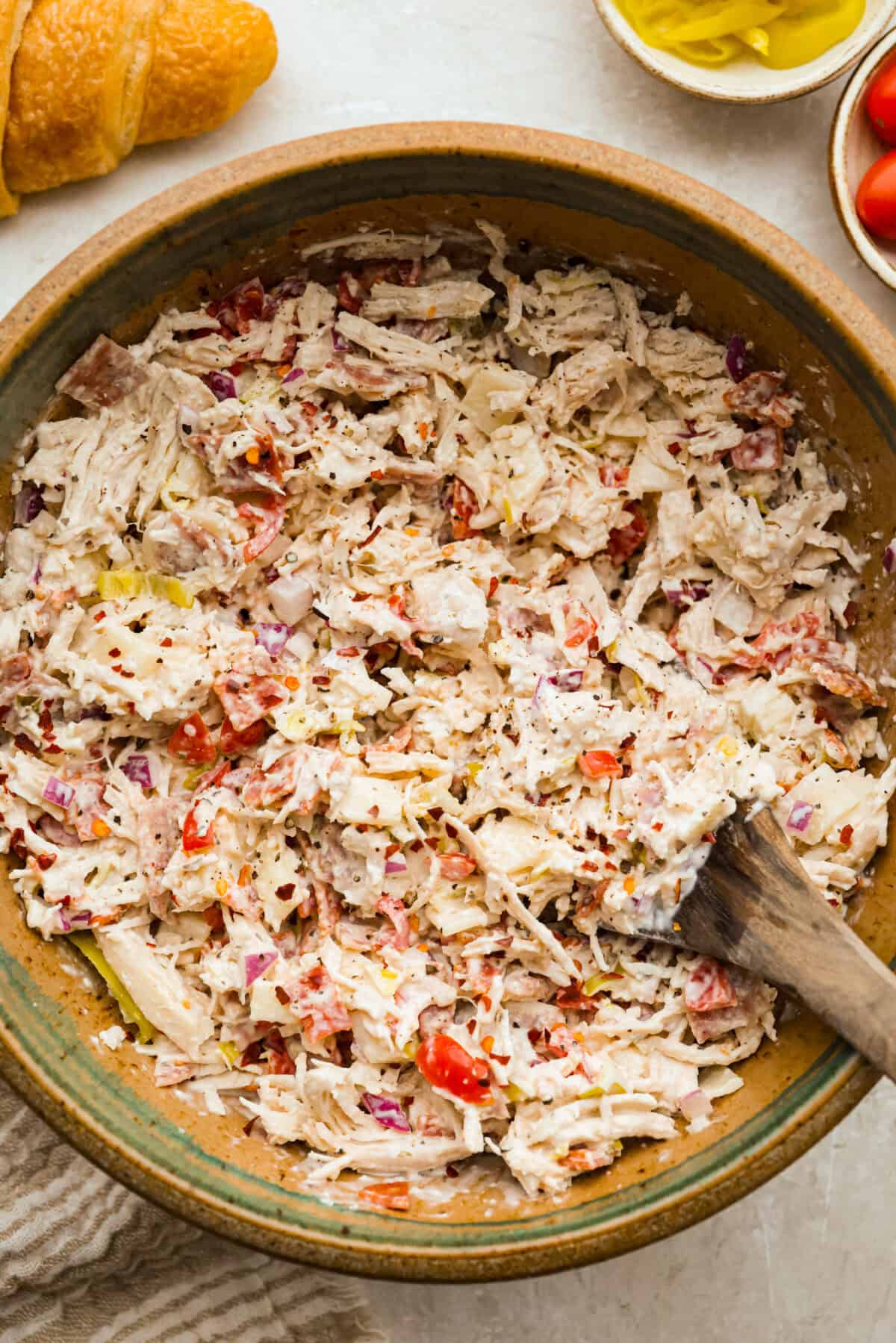 I know you guys love my famous grinder sliders. This grinder chicken salad brings all those bold flavors into one easy recipe. It's hearty, creamy, and perfect for lettuce wraps or a quick lunch straight from the bowl. Overhead shot of grinder chicken salad in a large bowl.