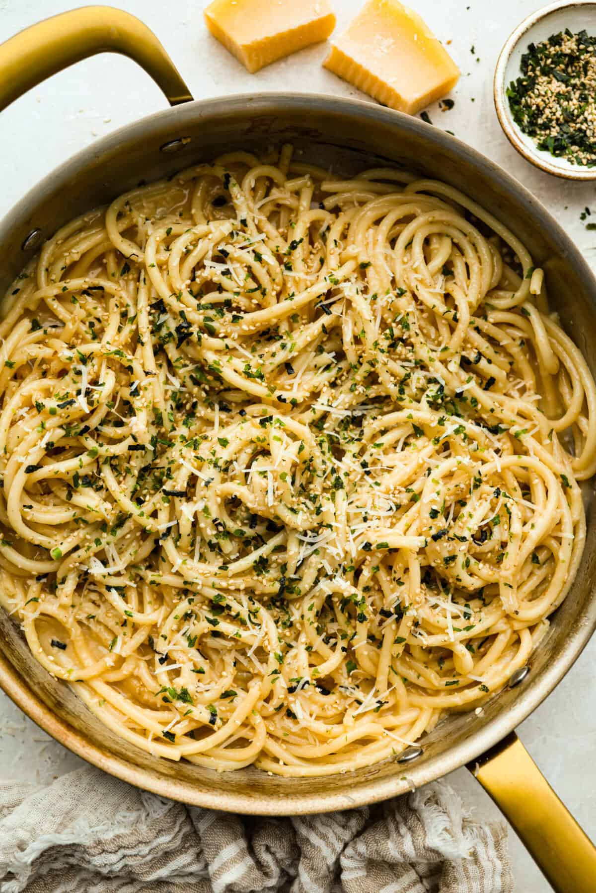 My 5-ingredient miso pasta turns pantry staples into something you'd swear came from a restaurant kitchen. Butter, garlic, and miso melt together into a rich, savory sauce that clings to every strand of bucatini. Overhead shot of a skillet full of miso pasta garnished and ready to eat.