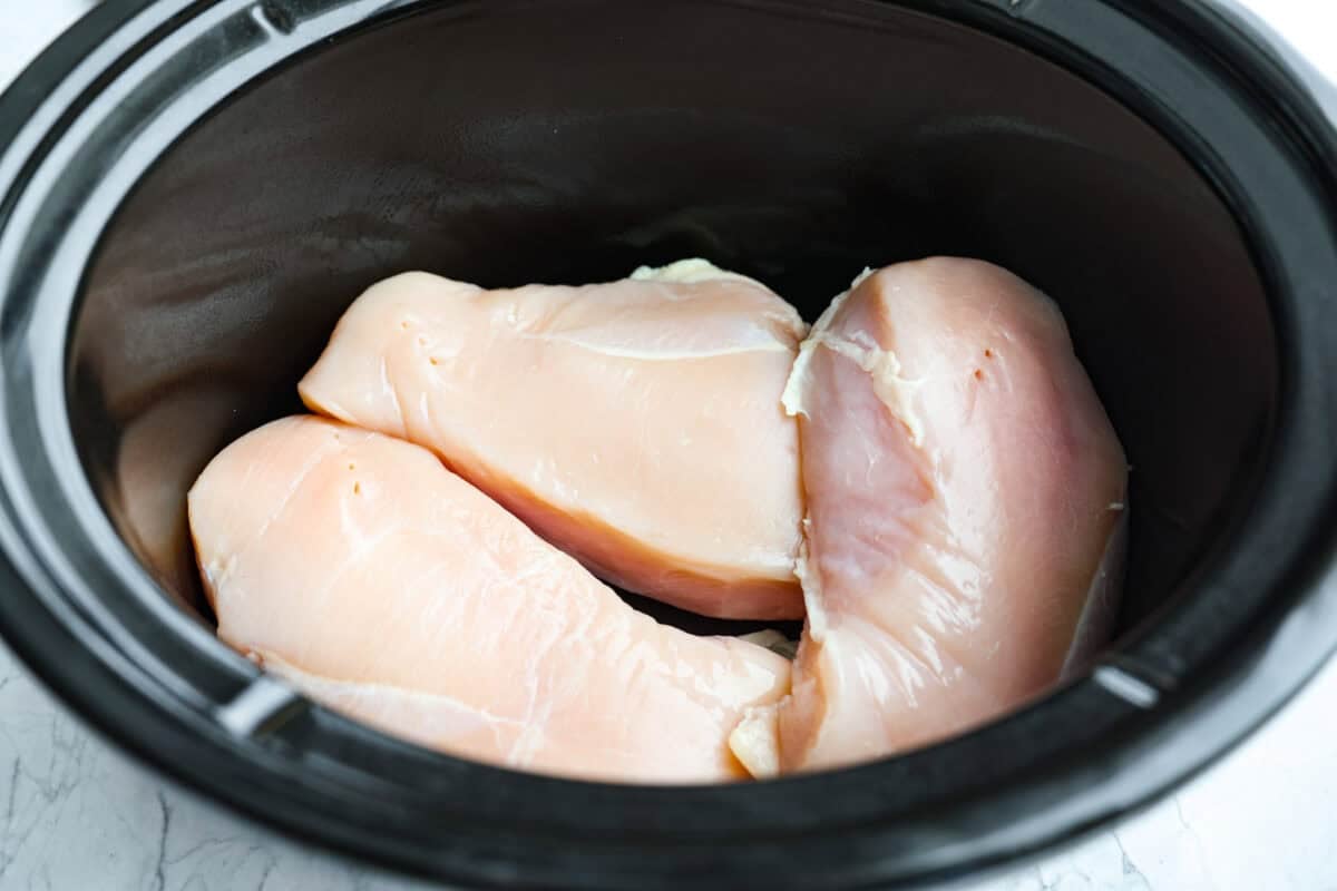 Slow cooker Aloha chicken is sweet, smoky, and so easy to throw together! Tender chicken cooks with pineapple, onion, and barbecue sauce until it’s full of flavor and ready to shred. Serve it over rice for a simple dinner the whole family will love. Slow cooker with chicken breasts added.