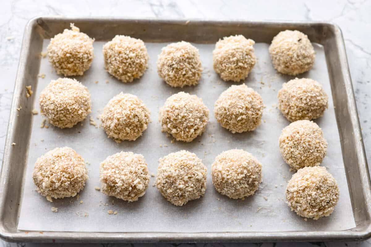 Chicken parmesan meatballs bring all the best parts of chicken parmesan together in one skillet. Think tender chicken meatballs, crispy Parmesan breadcrumbs, saucy marinara, and lots of melted mozzarella. Meatballs formed and coated in the breadcrumb and parmesan mixture.
