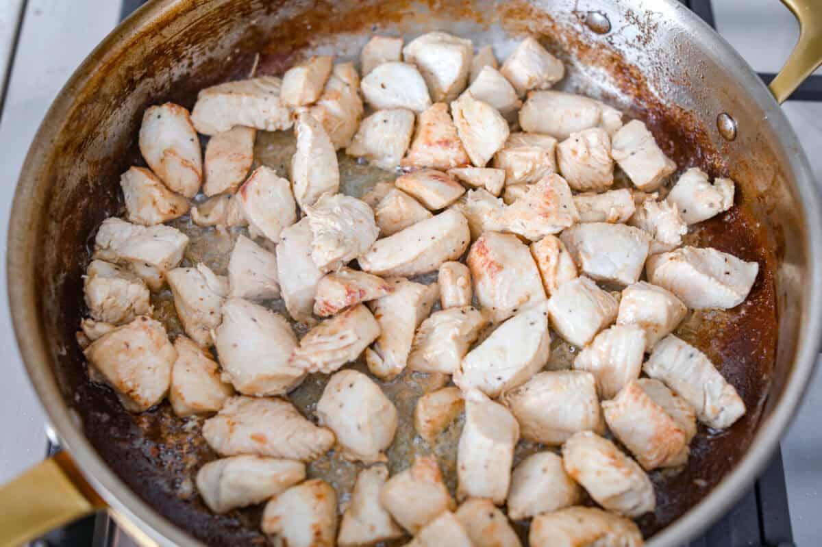 Chicken Caesar pasta is the kind of dinner you’ll want on repeat. You loved my Caesar Chicken Bake, so I turned those same creamy, savory flavors into an easy skillet pasta! It’s cozy, cheesy, and topped with crunchy croutons. chicken cooking in a skillet.