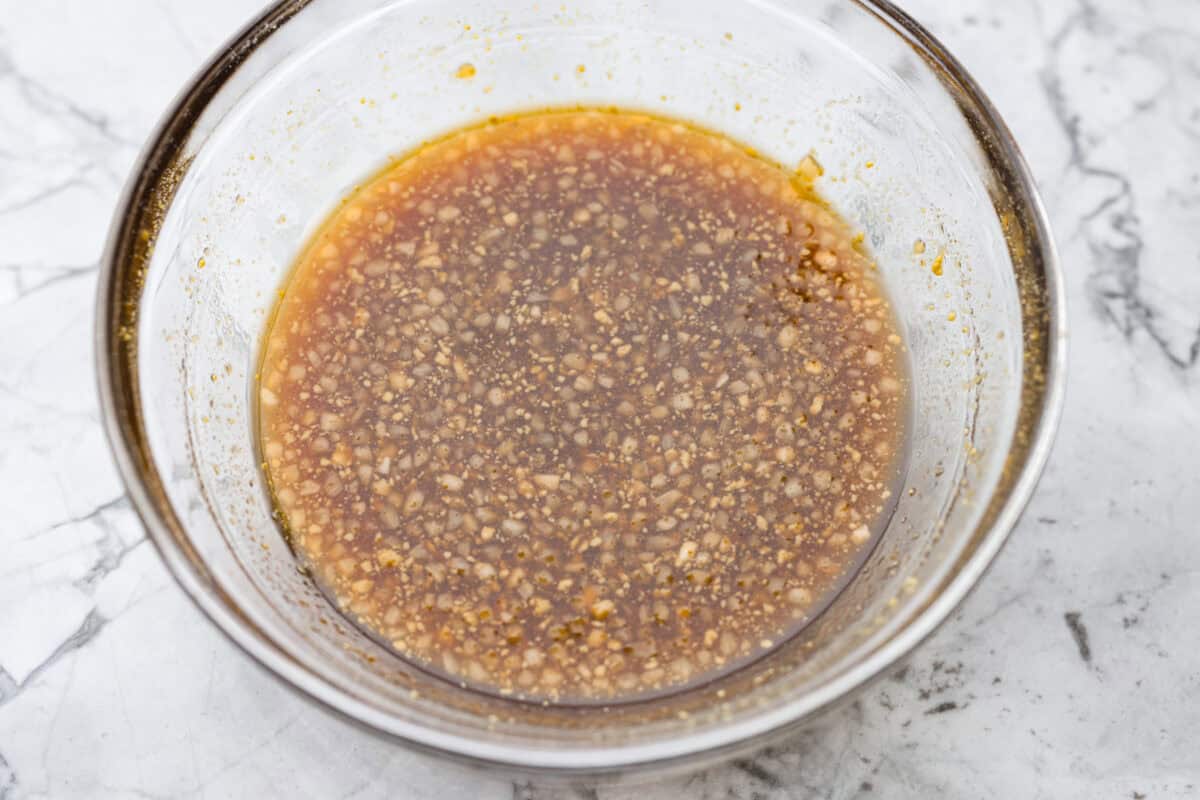Maple glazed salmon has that perfect sweet-and-savory flavor that keeps you going back for just one more bite. As it bakes, the maple glaze turns glossy and caramelized while the salmon stays buttery, flaky, and melt-in-your-mouth tender. Maple glaze sauce ingredients whisked together in a bowl.
