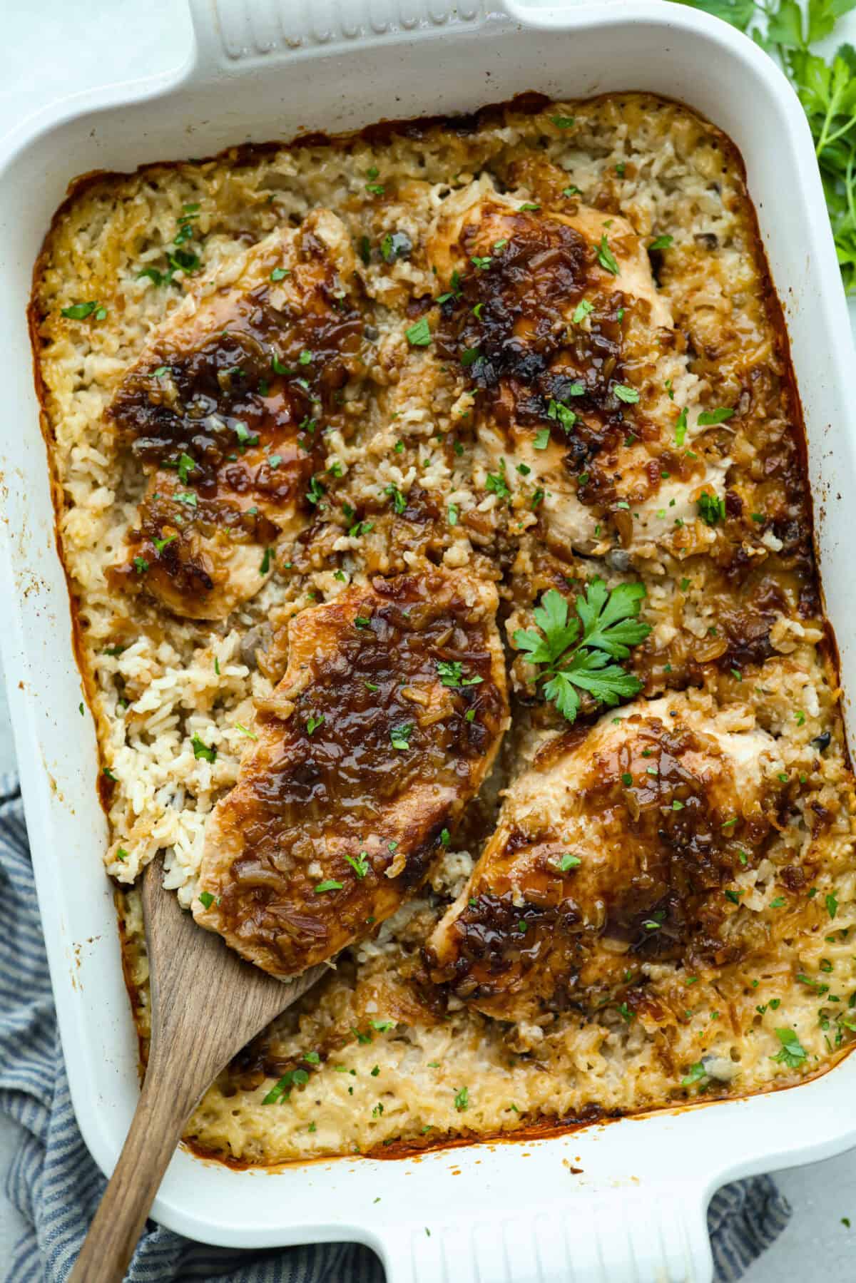 No peek chicken and rice casserole is the ultimate easy comfort food. Tender chicken and creamy, flavorful rice bake together in one dish. Just cover it tightly, pop it in the oven, and whatever you do, don’t peek! Baking dish filled with no peek chicken and rice casserole.