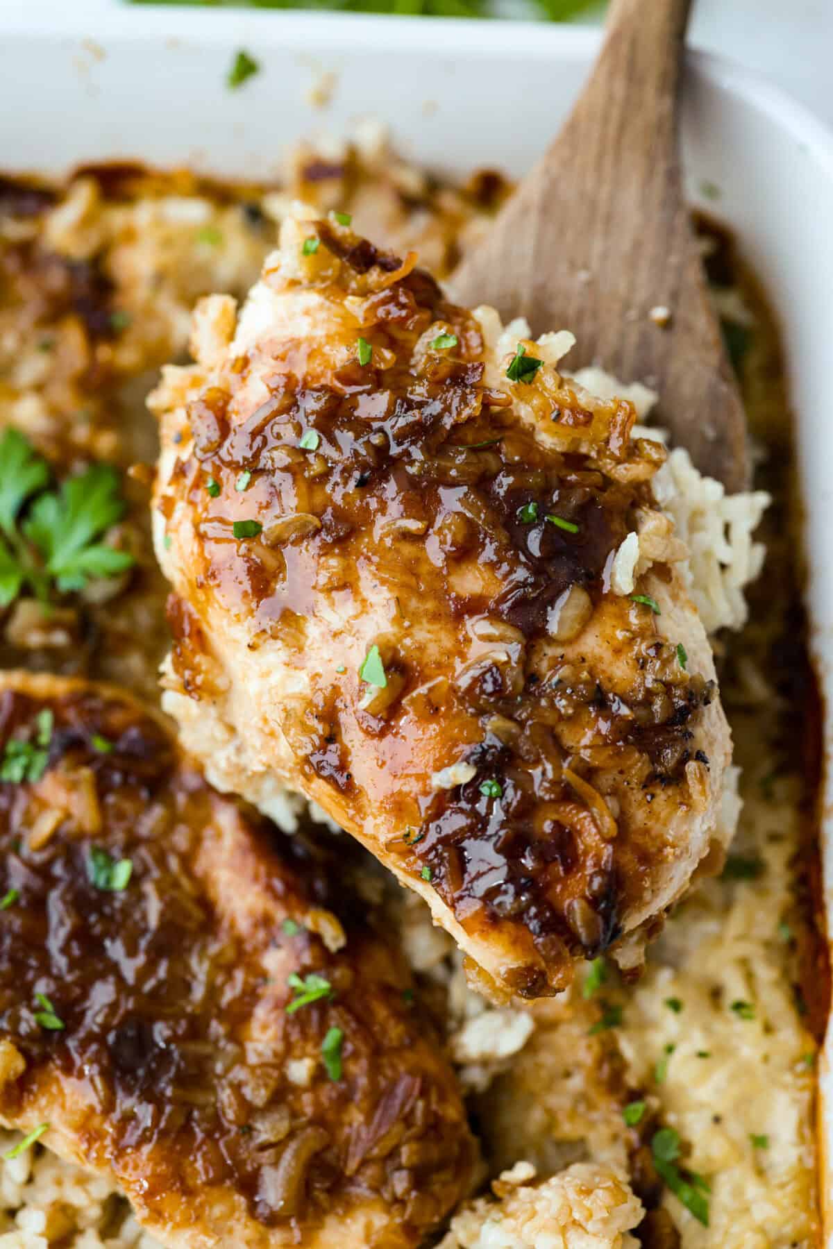 , then sprinkle with onion soup mix. Close up shot of a no peek chicken and rice casserole serving being lifted with a spatula.