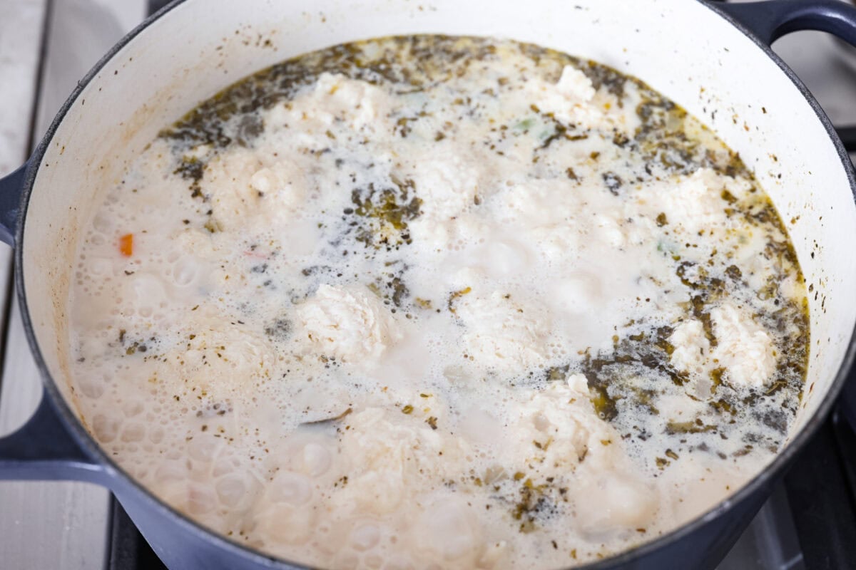 Chicken and dumpling soup will have everyone racing to the table! This one-pot dinner is loaded with tender chicken, hearty vegetables, and a creamy broth. Soft homemade dumplings steam right on top for the perfect finishing touch. Chicken and dumpling batter added to the top of the soup.